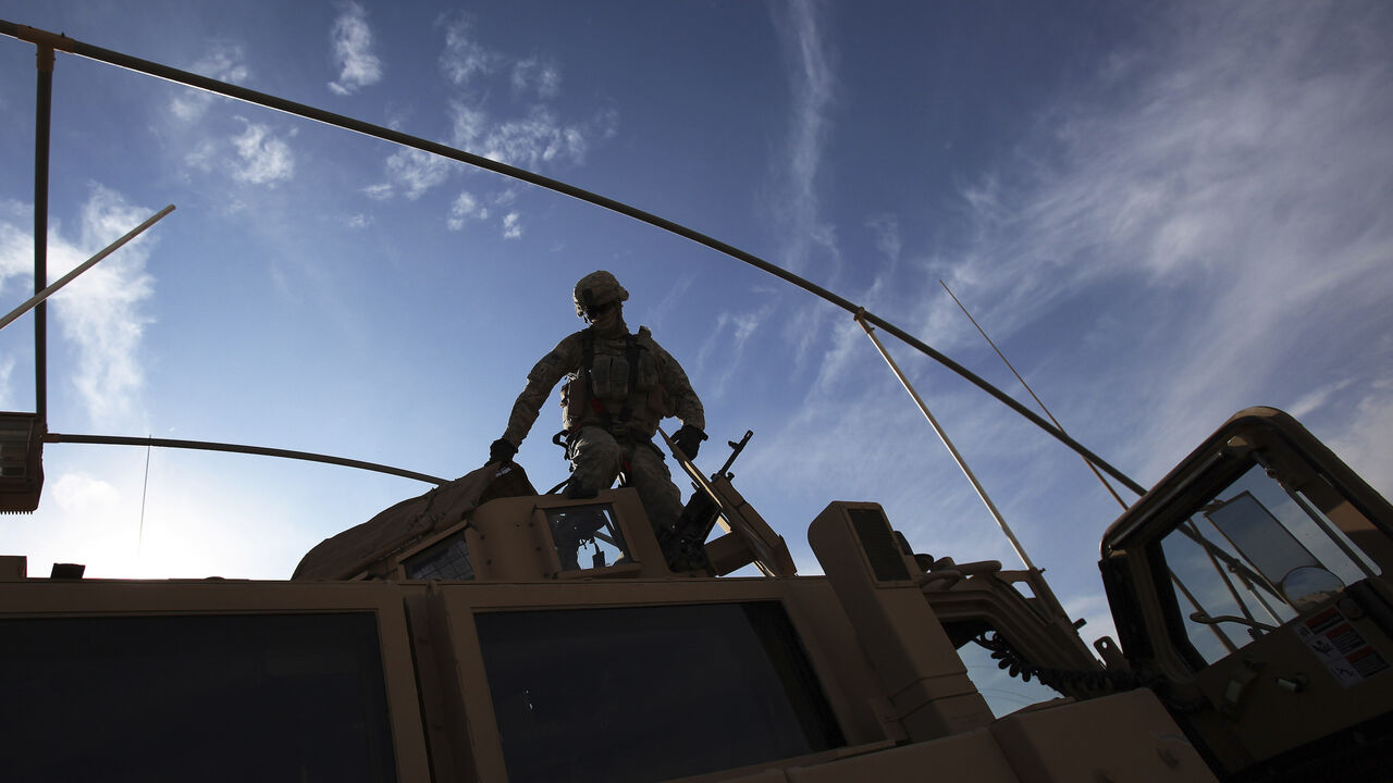 A U.S. Army soldier from the 2nd Brigade 82nd Airborne Division gets out of his Mine Resistant Ambush Protected (MRAP) vehicle after arriving at Camp Kalsu near Hillla, December 5, 2011. The brigade arrived from Taji, which is 20 miles (32 km) north of Baghdad on route to withdrawal from Iraq. REUTERS/Shannon Stapleton   (IRAQ - Tags: MILITARY CONFLICT) - GM1E7C60FJF01