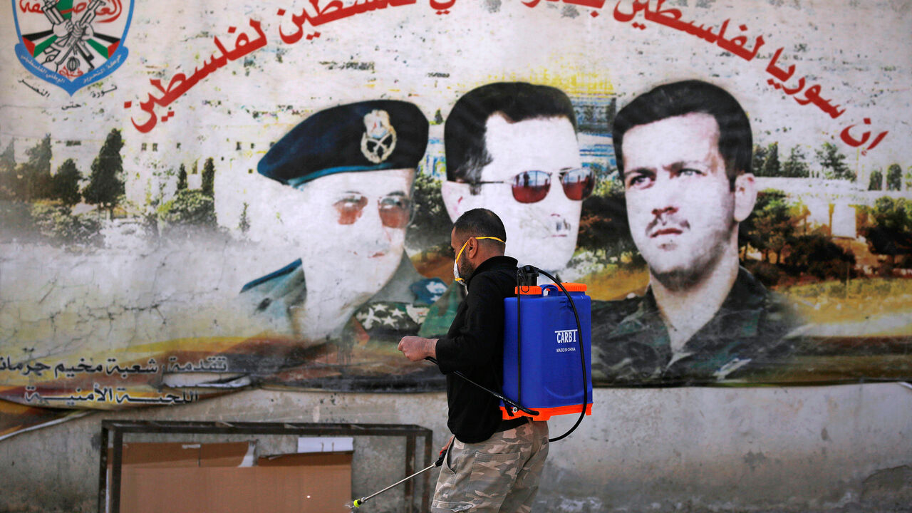 A man sprays disinfectant to curb the spread of the coronavirus disease (COVID-19), inside Jaramana Palestinian refugee camp in Damascus, Syria April 1, 2020. Picture taken April 1, 2020.  REUTERS/Omar Sanadiki - RC29WF9SNKKP