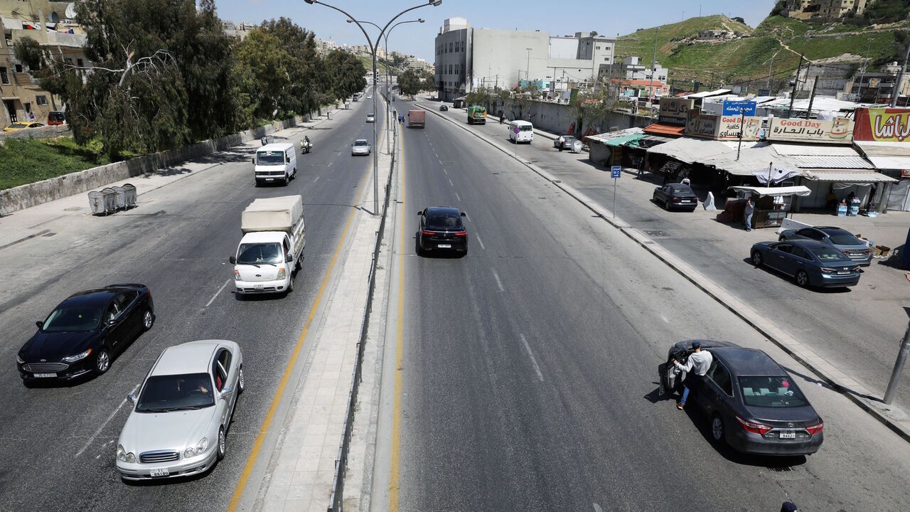 Jordanian police check the electronic passes, amid concerns over the spread of the coronavirus disease (COVID-19), at a checkpoint in Amman, Jordan April 8, 2020. REUTERS/Muhammad Hamed - RC2D0G93LSTB