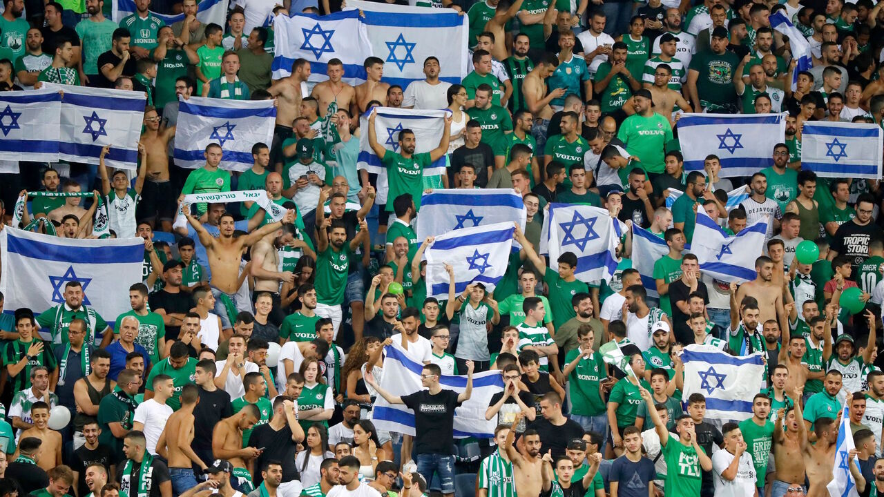 Maccabi fans cheer for their team prior to the second leg of the Europa league second round qualifier football match between Maccabi Haifa and RC Strasbourg at the Sammy Hofer stadium in Haifa on August 1, 2019. (Photo by Jack GUEZ / AFP)        (Photo credit should read JACK GUEZ/AFP via Getty Images)