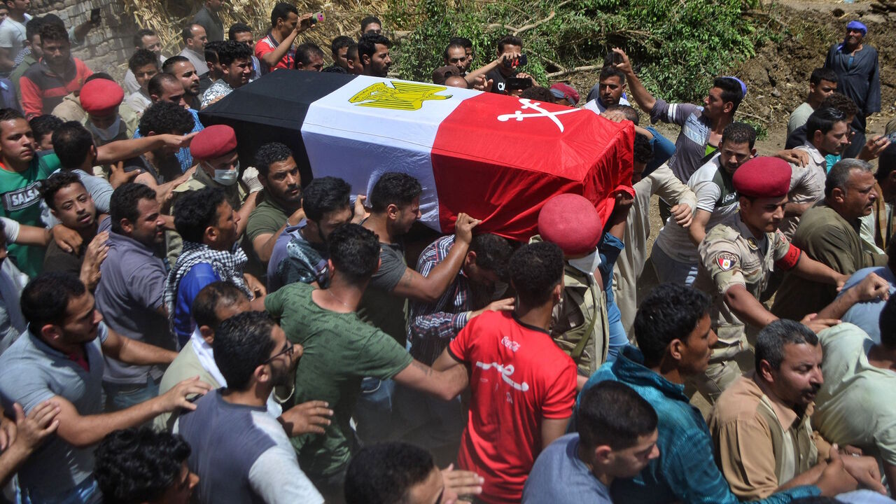 Mourners carry the coffin of Alaa Emad, an Egyptian soldier who was killed in an explosion targeting an armoured vehicle near Bir al-Abed in North Sinai, during his funeral in the vilage of Abwan in the Minya province on May 1, 2020. - Egypt's army said Thursday that 10 soldiers, including an officer, were killed or wounded in an explosion that day targeting an armoured vehicle near Bir al-Abed in North Sinai. The Egyptian army killed two suspected jihadists Friday in restive North Sinai, a day after a blas