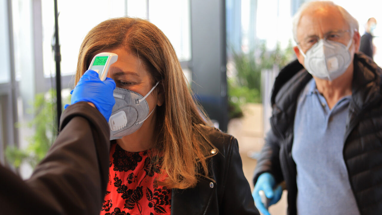 TEL AVIV, ISRAEL - MAY 14: A passenger has her temperature checked before being allowed entry to Ben Gurion Airport on May 14, 2020 near Tel Aviv, Israel. Authorities are preparing for the full reopening of the airport, Israel's main gateway, by June 1, 2020 as coronavirus cases across the country continue to decline. According to reports only visitors from countries with low infection rates and compulsory protective equipment laws will be granted entry while Israelis will need to report to the Health Minis