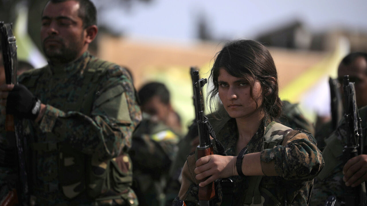 A fighter of Syrian Democratic Forces (SDF) holds her weapon as they announce the destruction of Islamic State's control of land in eastern Syria, at al-Omar oil field in Deir Al Zor, Syria March 23, 2019. REUTERS/Rodi Said     TPX IMAGES OF THE DAY - RC1FE8C72C90