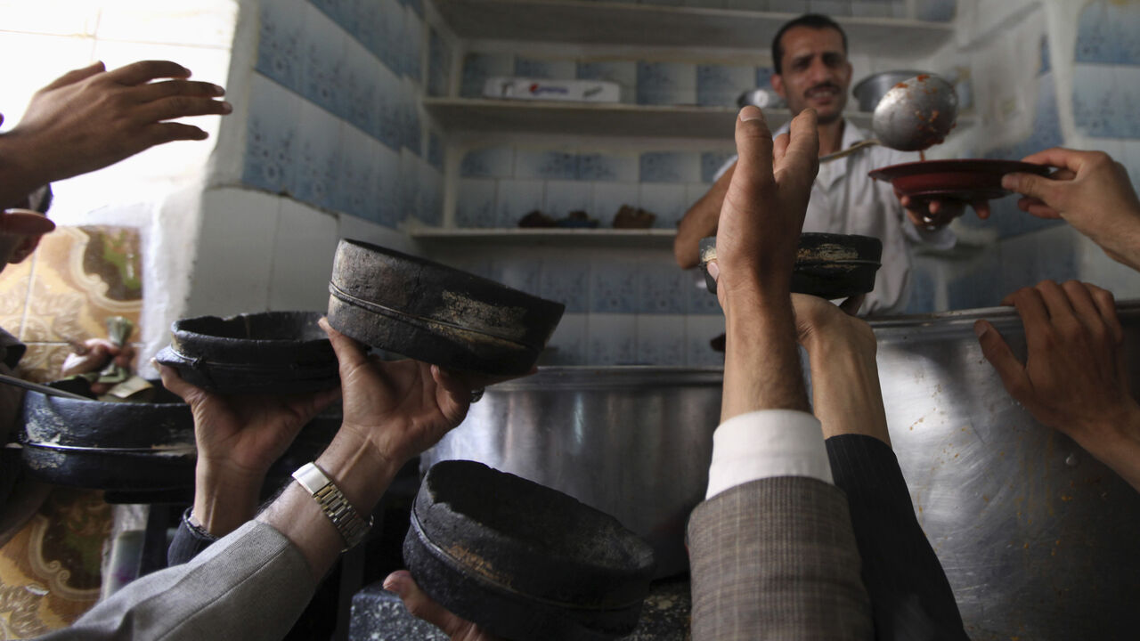 Customers order a popular Yemeni meal known as Al-Saltah, at a restaurant in Sanaa July 3, 2013. According to the United Nations, there are approximately five million people in Yemen who are either suffering from food insecurity or are at risk of acute food insecurity caused by rising food and fuel prices and political instability. REUTERS/Mohamed al-Sayaghi (YEMEN - Tags: FOOD SOCIETY BUSINESS) - GM1E97401O501