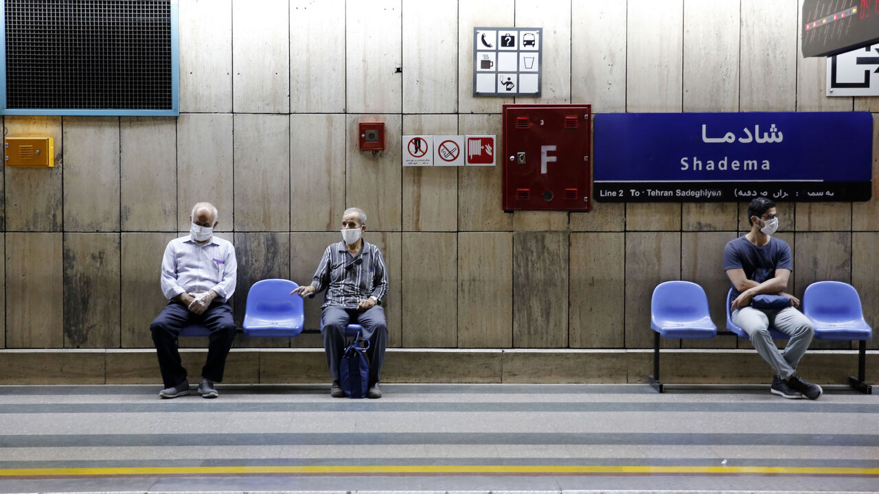Iranian men wearing face masks are pictured at a metro station in the capital Tehran on June 10, 2020 amid the coronavirus Covid-19 pandemic crisis. - Nearly one in five Iranians may have been infected with the novel coronavirus since the country's outbreak started in February, a health official said yesterday. The figure represents 18.75 percent of the more than 80 million population of Iran, which on June 9 announced another 74 deaths from the coronavirus. (Photo by STRINGER / AFP) (Photo by STRINGER/AFP 