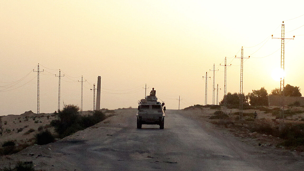 FILE PHOTO: An Egyptian military vehicle is seen on the highway in northern Sinai, Egypt, May 25, 2015.   To match Special Report EGYPT-POLITICS/SINAI      REUTERS/Asmaa Waguih/File Photo - RC17BB4CC790