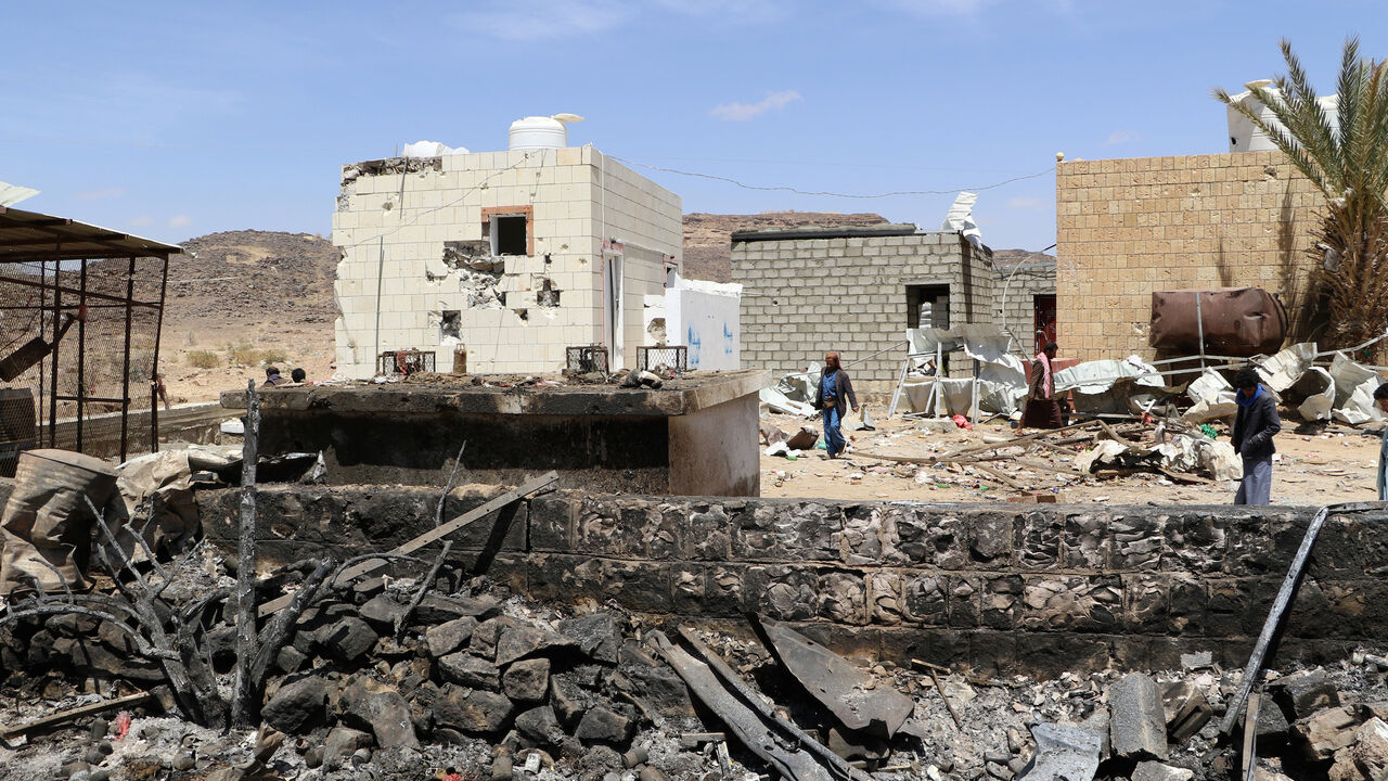 People walk at the scene of an air strike that hit a gas station near a hospital in Kutaf district of the northwestern province of Saada, Yemen March 28, 2019. REUTERS/Naif Rahma - RC1B84944380