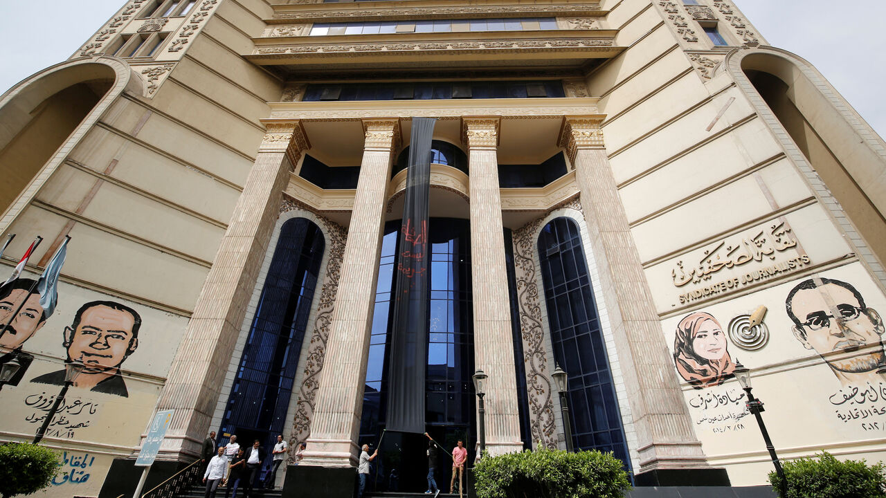 Journalists put a black sign reads "The press, It is not a crime" on World Press Freedom Day at the syndicate's headquarters in downtown Cairo, Egypt May 3, 2016. REUTERS/Amr Abdallah Dalsh - S1BETBXZDRAA