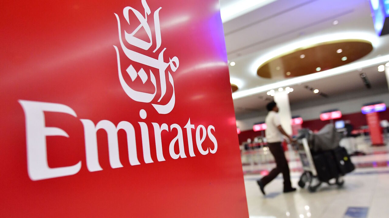 A passenger walks past an Emirates airlines logo at Dubai International Airport's  T3 in the United Arab Emirates on October 10, 2018. -  (Photo by GIUSEPPE CACACE / AFP)        (Photo credit should read GIUSEPPE CACACE/AFP via Getty Images)