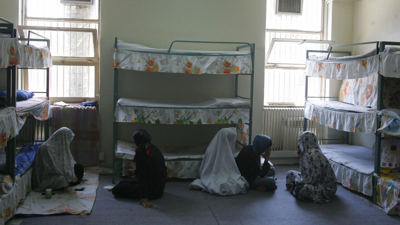 Tehran, IRAN:  TO GO WITH AFP STORY IRAN-JUSTICE-PRISON-SOCIT BY PIERRE CELERIER  Iranian women inmates sit at their cell in the infamous Evin jail, north of Tehran, 13 June 2006. AFP PHOTO/ATTA KENARE  (Photo credit should read ATTA KENARE/AFP via Getty Images)