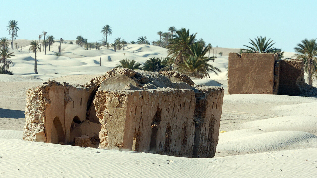 DOUZ, TUNISIA:  An abandoned Berber village sits in dunes in the vicinity of Zaafarane, near the southern Tunisian town of Douz, 24 December 2006 as the 39th International Sahara Festival opens. The festival, held 600 kms (370 miles) south of Tunis, draws locals and tourists for a cultural event that celebrates the region's heritage and desert people. AFP PHOTO FETHI BELAID  (Photo credit should read FETHI BELAID/AFP via Getty Images)