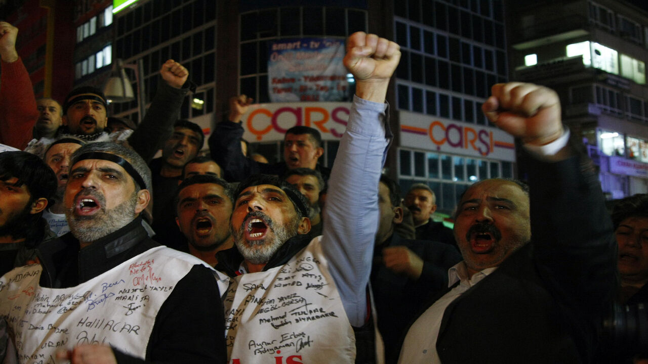 Turkish workers of former state-owned tobacco and alcohol monopoly TEKEL shout slogans in protest against layoffs and the government�s labor policy on the 65th day of their strike in Ankara on February 18, 2010. Workers are demonstrating for the rights of some 10,000 workers who were made redundant by the privatization of the state tobacco monopoly TEKEL in 2008. AFP PHOTO/ADEM ALTAN (Photo credit should read ADEM ALTAN/AFP via Getty Images)