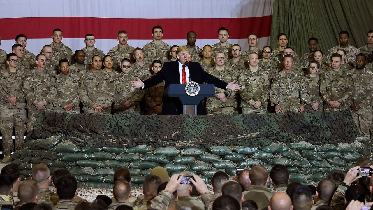 (FILES) In this file photo taken on November 28, 2019, US President Donald Trump speaks to the troops during a surprise Thanksgiving day visit at Bagram Air Field in Afghanistan. - President Donald Trump has shattered through norms and niceties on the world stage in his nearly three years in office. Entering an election year, Trump is unlikely to slow down as he seeks what has largely eluded him -- a headline-grabbing victory. The tycoon turned president closes 2019 with a new stride after what was perhaps 