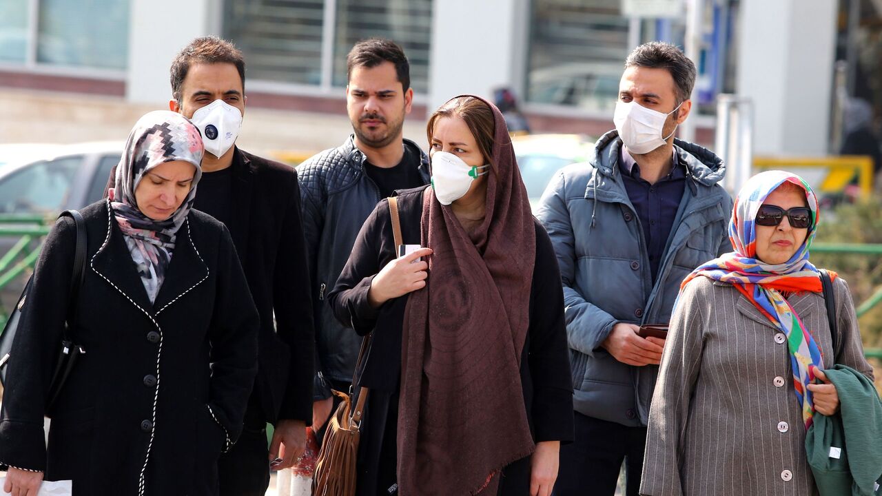 Iranians, some wearing protective masks, wait to cross a street in the capital Tehran on February 22, 2020. - Iran today reported one more death among 10 new cases of coronavirus, bringing the total number of deaths in the Islamic republic to five and infections to 28. (Photo by ATTA KENARE / AFP) (Photo by ATTA KENARE/AFP via Getty Images)