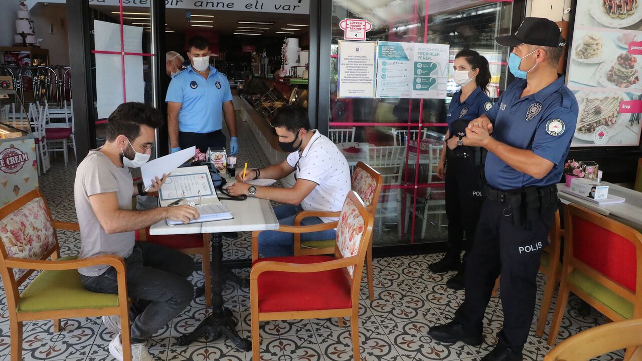 Turkish police officers and paramedics inspect a restaurant as new measures are enforced to fight against the novel coronavirus (Covid-19), in Ankara on August 6, 2020. - Following the "Coronavirus Inspections" orders sent by Interior Ministry to governorships, inspections were carried out in marketplaces, workplaces, markets, public transportation vehicles, shopping areas, restaurants, cafeterias and taxis. Turkey has expressed concern over the rising number of coronavirus cases as the daily infection toll