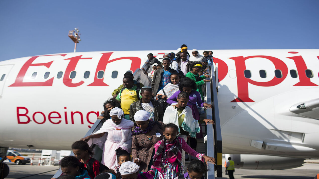 TEL AVIV, ISRAEL - AUGUST 28:  New Jewish immigrants walking down the airplane during a welcoming ceremony after arriving on a flight from Ethiopia, on August 28, 2013 at Ben Gurion airport near Tel Aviv, Israel. Over 400 Ethiopian Jews arrived on the flight to Tel Aviv, the last of a series of monthly flights that were part of Operation Dove's Wings, an Israeli government initiative to bring to Israel the remainder of the Falash Mura, members of the Ethiopian Jewish community whose ancestors converted to C