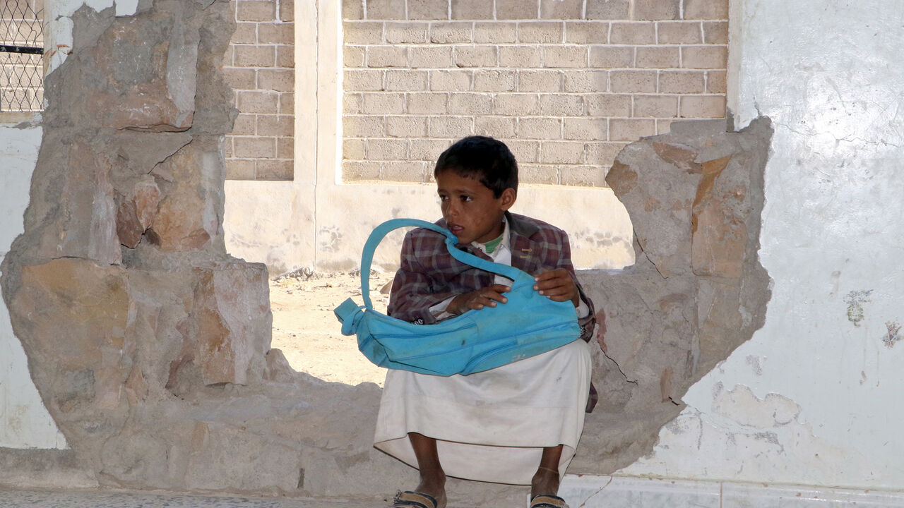 A Yemeni boy sits in a hole in a wall at a school that was damaged in the country's ongoing conflict between the Saudi-led Arab coalition fighting Shiite Huthi rebels in the northern province of Saada, on March 14, 2017.
The conflict in Yemen, which escalated with the intervention of the Saudi-led coalition two years ago, has more than doubled the number of children deprived of schooling to some 3.5 million, threatening the future of a whole generation in the impoverished country. / AFP PHOTO / STRINGER / T