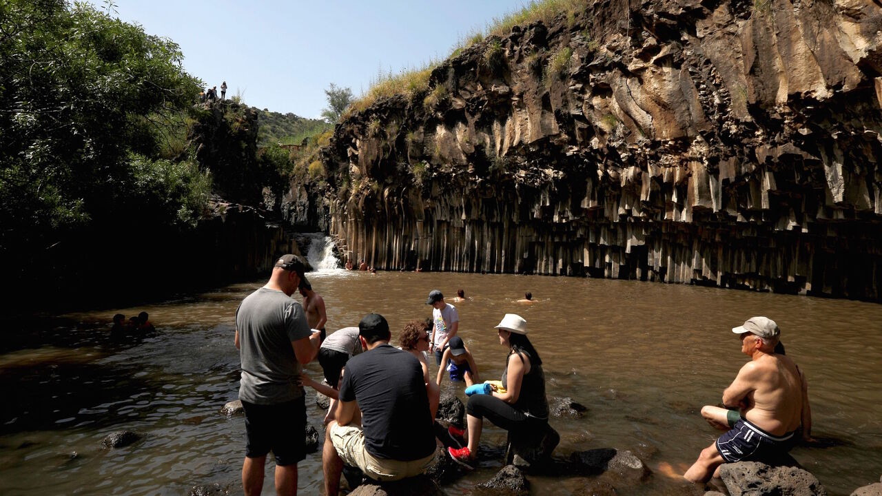 Tourists bath in the Hexagons pool, near the Had Nes settlement in the Israel-annexed Golan Heights on April 26, 2019. - The Hexagons pool, also known as the Meshushim pool, is a natural pool fed by the Nature Reserve Meshushim River. (Photo by JALAA MAREY / AFP) (Photo by JALAA MAREY/AFP via Getty Images)