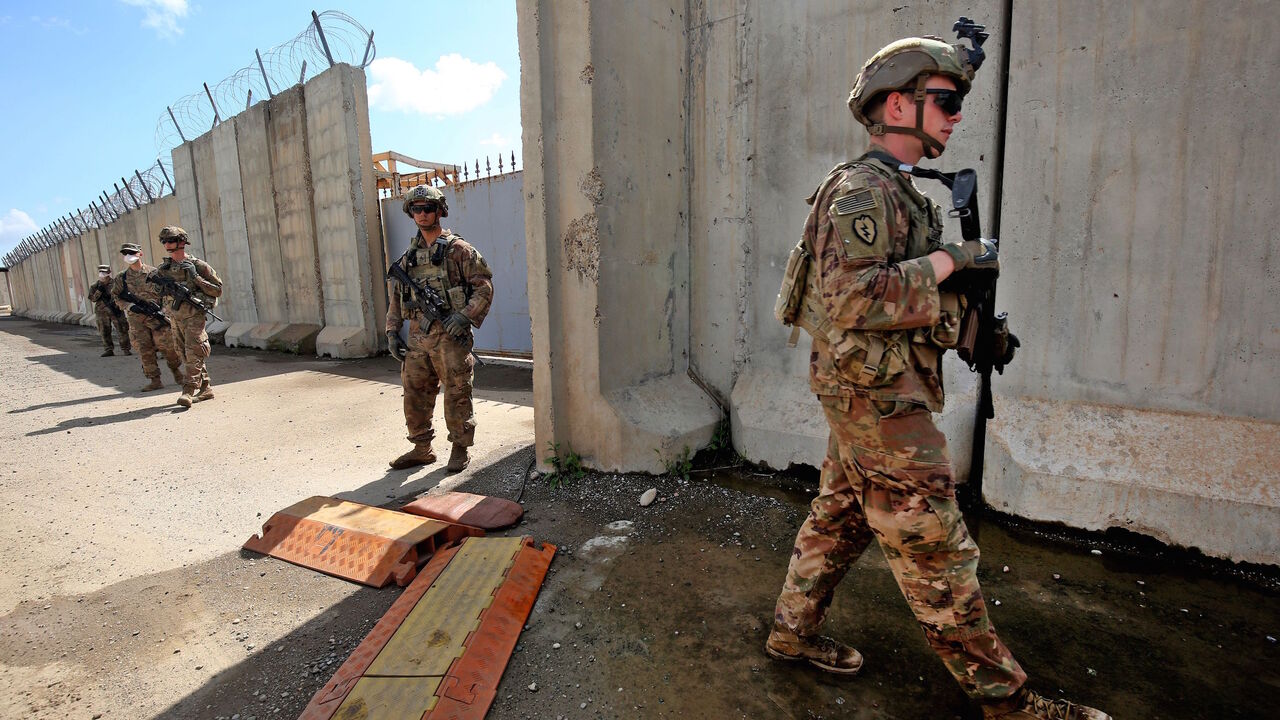 US army soldiers, part of the Combined Joint Task Force  Operation Inherent Resolve (CJTF-OIR) the US-led coalition against the Islamic State (IS) group, walk around at the K1 Air Base northwest of Kirkuk in northern Iraq before a planned US pullout on March 29, 2020. (Photo by AHMAD AL-RUBAYE / AFP) (Photo by AHMAD AL-RUBAYE/AFP via Getty Images)