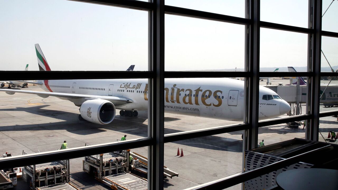 This picture taken on July 17, 2020 shows an Emirates Boeing 777-31H aircraft disembarking passengers upon arrival at the Iranian capital Tehran's Imam Khomeini International Airport. - The UAE's Emirates airlines landed its first flight in Tehran on July 17 after a five month shutdown due to the novel coronavirus pandemic. (Photo by - / AFP) (Photo by -/AFP via Getty Images)
