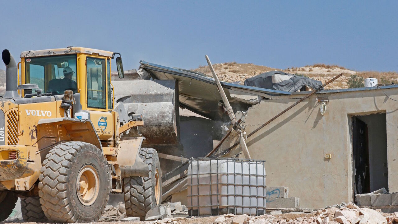 Israeli authorities demolish a Palestinian house in the southern West Bank village of Khirbet Jinba on September 2, 2020, since it was reportedly built in "Area C" without Israeli authorisation. - "Area C" is a stretch of land accounting for 60 percent of the West Bank over which Israel has control under the terms of the Oslo Accords signed between Israel and the Palestinians in the 1990s. It is extremely difficult for Palestinians to receive building permits from Israeli authorities for that area. (Photo b