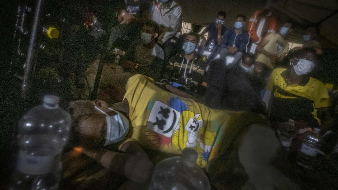 Dozens of migrants, from Egypt, Morocco, Somalia and Sierra Leone, are assisted by a team of aid workers of the Spanish NGO Open Arms, after spending more than 20 hours at sea while fleeing Libya on board a precarious boat in international waters, in the Central Mediterranean sea, on September 08, 2020. (Photo by Ricardo GARCIA VILANOVA / AFP) (Photo by RICARDO GARCIA VILANOVA/AFP via Getty Images)