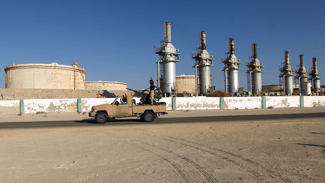 Forces opposed to Libya's unity government ride a truck in the Zueitina oil terminal on September 14, 2016.
Forces opposed to Libya's unity government handed management of four vital oil ports to the National Oil Company on September 14, after seizing them in a blow to fragile peace efforts. Prime minister-designate Fayez al-Sarraj called for urgent talks after the ports were captured by forces loyal to Field Marshal Khalifa Haftar, who supports a rival administration in the country's east.
 / AFP / Abdulla