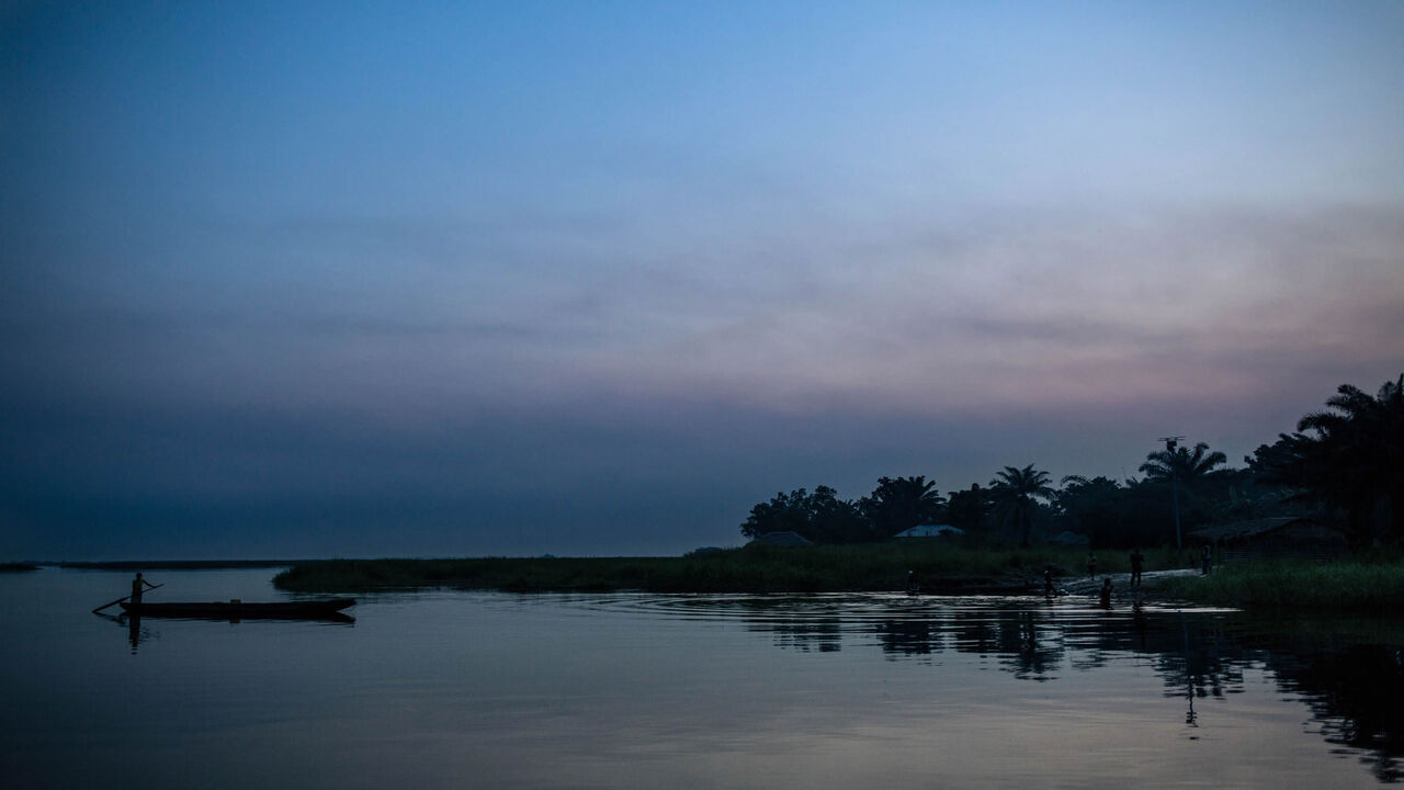 A man drives a canoe on the Congo River near Makotimpoko, Republic of Congo, on January 25, 2019. - In Makotimpoko, nearly 16,000 people found refuge as they fled the ethnically motivated mass killings across the river in the Democratic Republic of Congo. Between December 16 and 17, 2018, at least 535 people were killed in Yumbi Territory, according to the United Nations Joint Office for Human Rights. (Photo by ALEXIS HUGUET / AFP)        (Photo credit should read ALEXIS HUGUET/AFP via Getty Images)