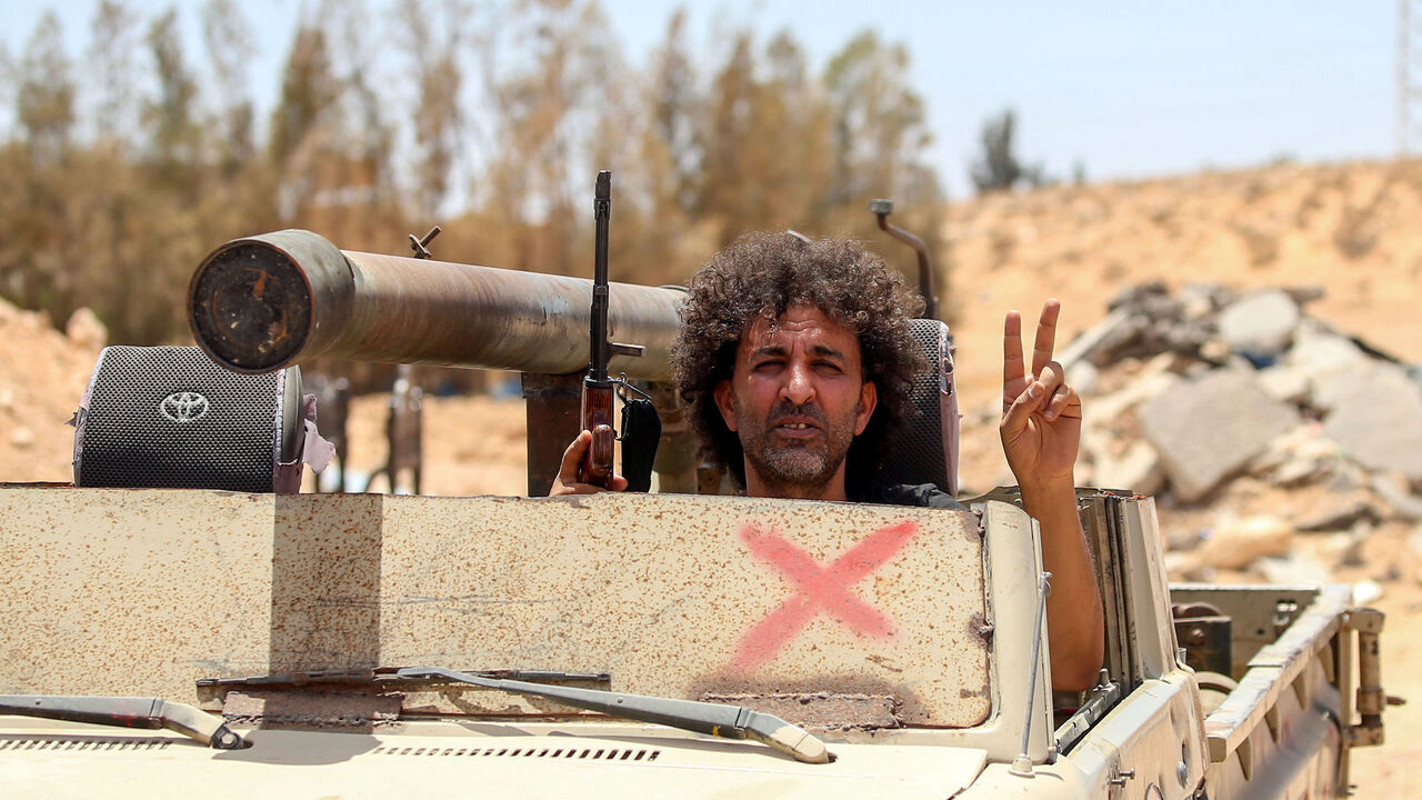 Fighters loyal to the UN-recognised Libyan Government of National Accord (GNA) secure the area of Abu Qurain, half-way between the capital Tripoli and Libya's second city Benghazi, against forces loyal to Khalifa Haftar, who is based in eastern Benghazi, on July 20, 2020. - Since 2015, a power struggle has pitted the (GNA) against forces loyal to Haftar. The strongman is mainly supported by Egypt, the United Arab Emirates and Russia, while Turkey backs the GNA. (Photo by Mahmud TURKIA / AFP) (Photo by MAHMU