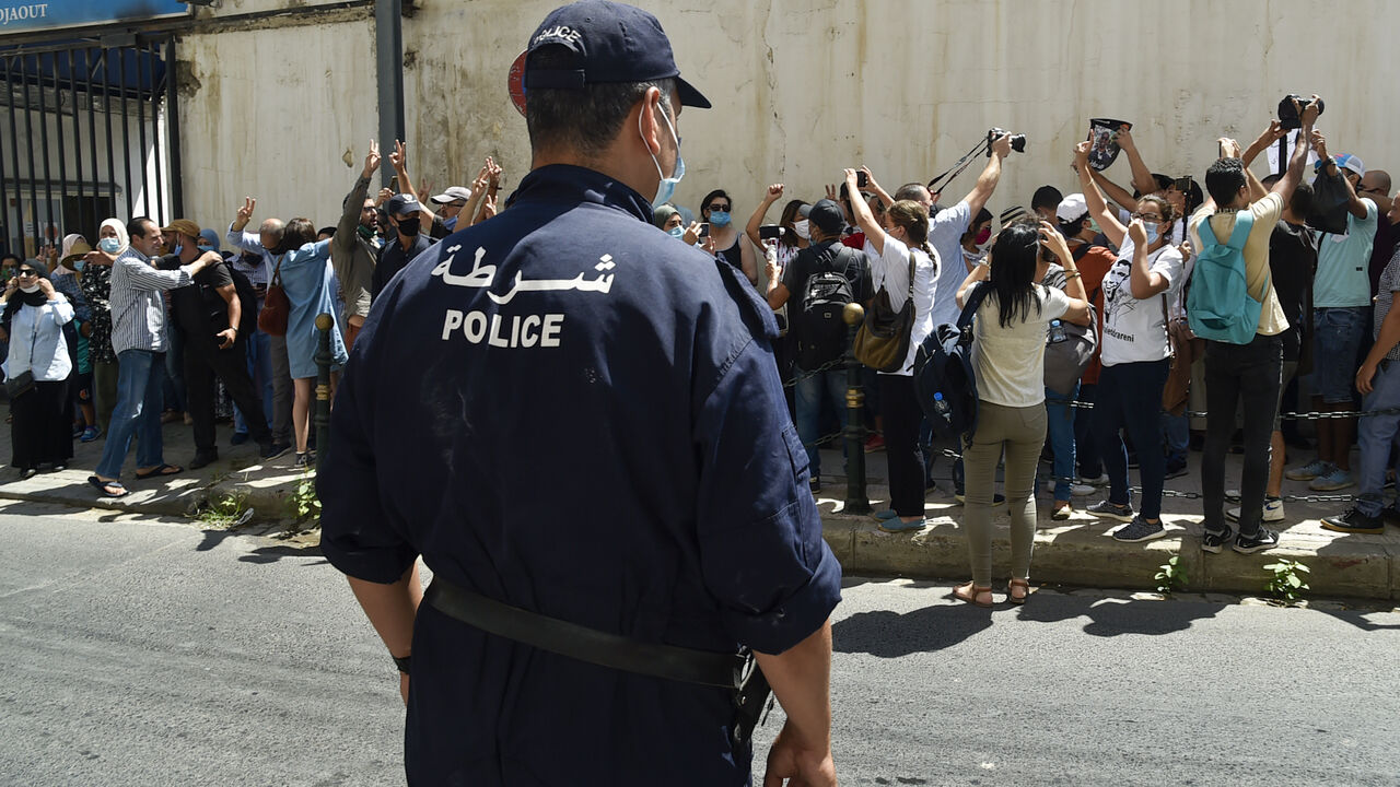 Algerian journalists gather in protest to demand the release of their colleague Khaled Drareni, who was sentenced earlier this month to three years in jail for "inciting an unarmed gathering" and "endangering national unity", in the capital Algiers on August 24, 2020. - The Algerian justice system has in recent months increased the court cases and convictions against alleged Hirak militants, opposition politicians, journalists and social media users. (Photo by RYAD KRAMDI / AFP) (Photo by RYAD KRAMDI/AFP vi