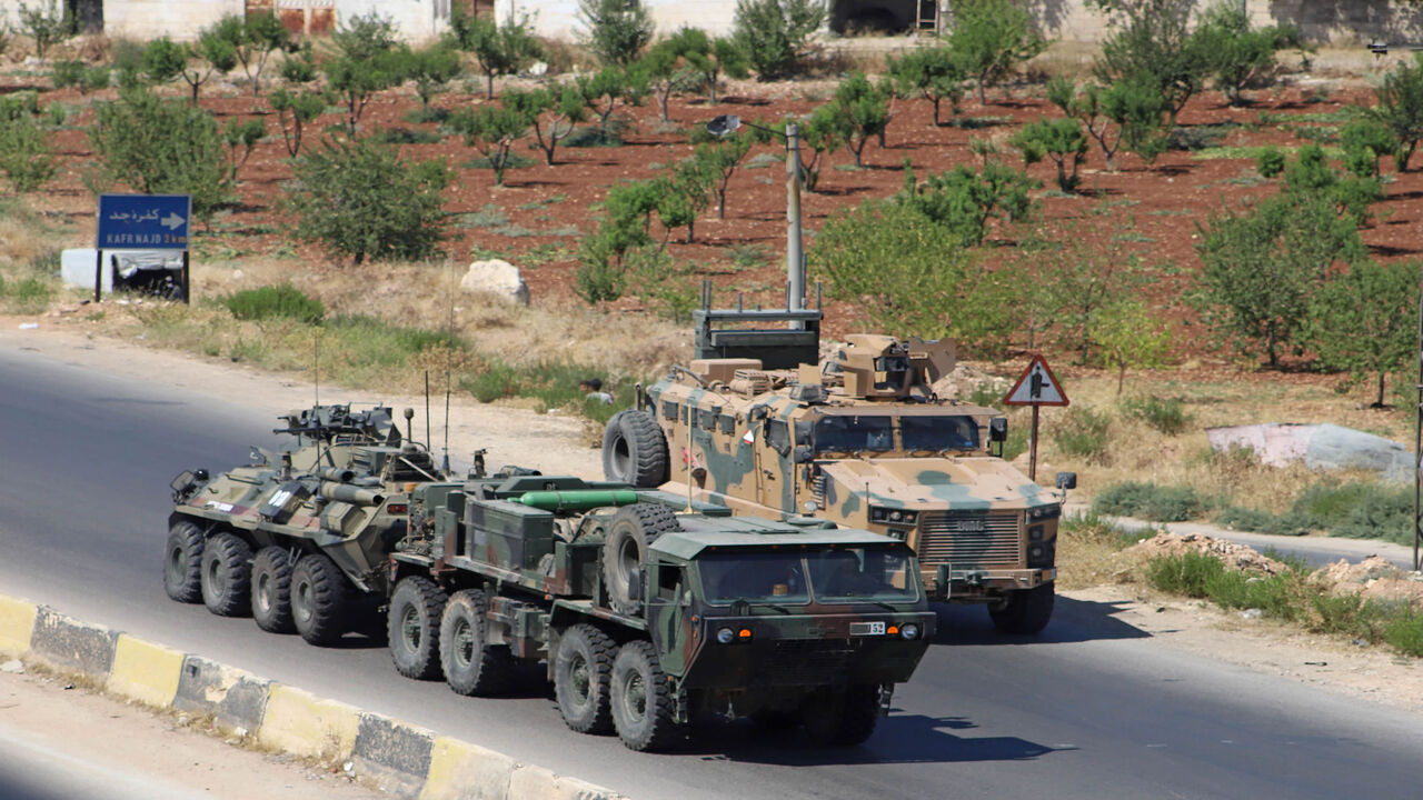 A Turkish-Russian military convoy tows a damaged vehicle after its joint patrol was reportedly targeted on the strategic M4 highway, near the Syrian town of Urum al-Jawz in the south of the northwestern Idlib province, on August 25, 2020. - Russia and Turkey launched joint patrols along the M4 highway in March following a ceasefire agreement aimed at stopping heavy fighting in and around Idlib, the last major bastion of anti-government forces in Syria's civil war. (Photo by Abdulaziz KETAZ / AFP) (Photo by 