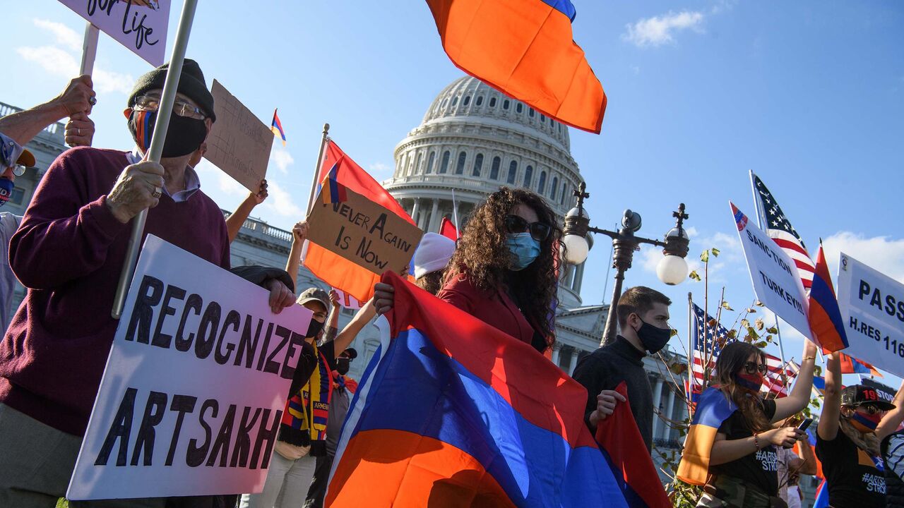 Armenian-Americans hold signs and flags as they protest against the conflict between Azerbaijan and the Armenian enclave of Nagorno-Karabakh and Turkey's support for Azerbaijan in front of the US Capitol in Washington, DC, on October 15, 2020. - US Secretary of State Mike Pompeo voiced hope Thursday that Armenia would "defend" itself against Azerbaijan, appearing to show sympathy to one side over the fierce clashes. (Photo by Nicholas Kamm / AFP) (Photo by NICHOLAS KAMM/AFP via Getty Images)