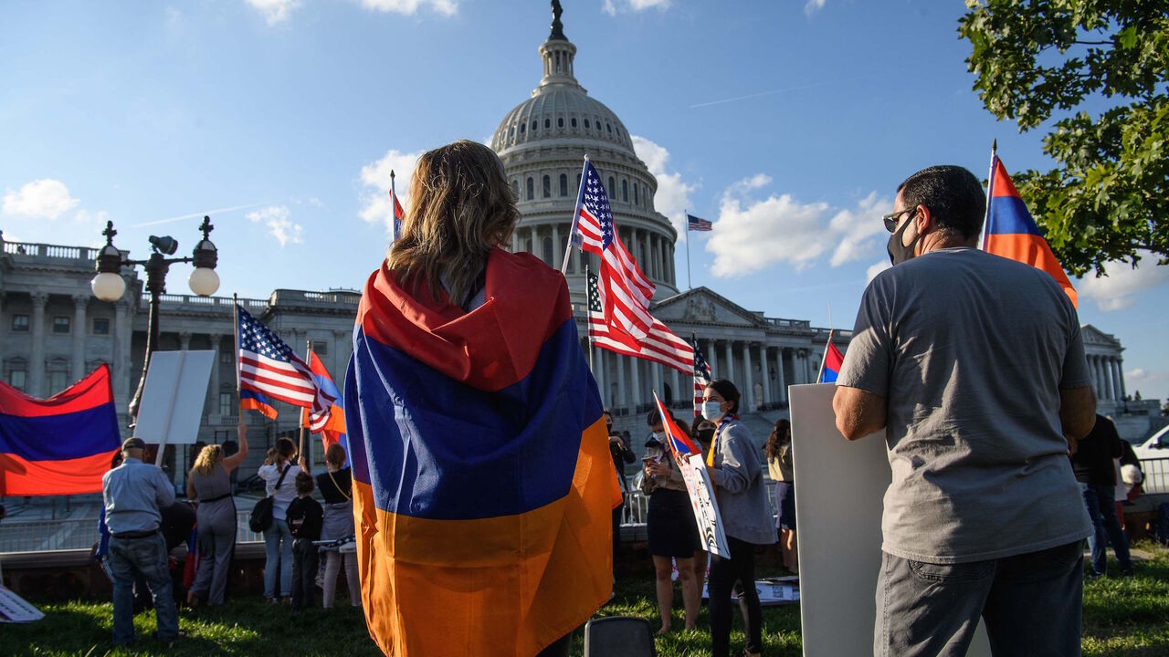 Armenian-Americans hold signs and flags as they protest against the conflict between Azerbaijan and the Armenian enclave of Nagorno-Karabakh and Turkey's support for Azerbaijan in front of the US Capitol in Washington, DC, on October 15, 2020. - US Secretary of State Mike Pompeo voiced hope Thursday that Armenia would "defend" itself against Azerbaijan, appearing to show sympathy to one side over the fierce clashes. (Photo by Nicholas Kamm / AFP) (Photo by NICHOLAS KAMM/AFP via Getty Images)