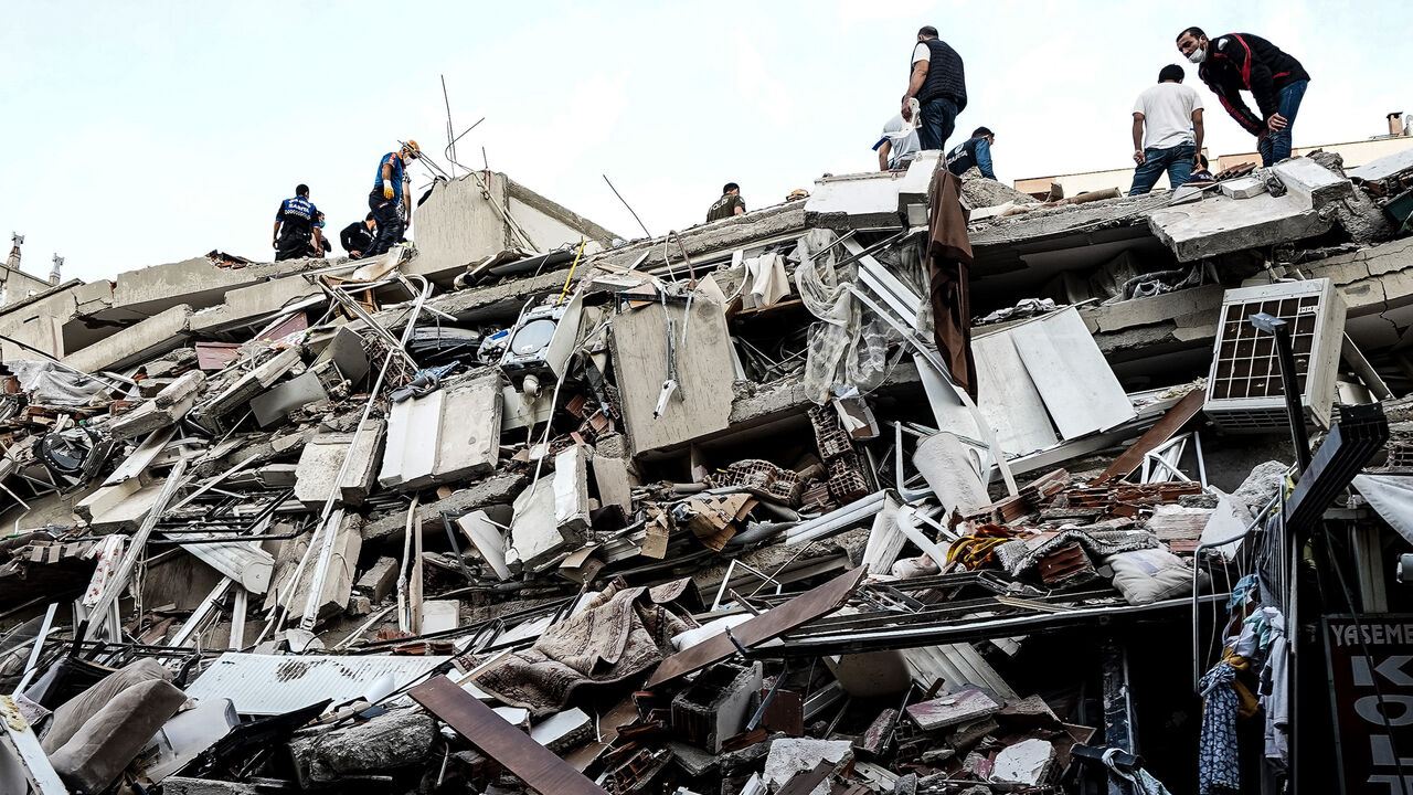 IZMIR, TURKEY - OCTOBER 30: Emergency services personnel search a collapsed building for survivors after a powerful earthquake struck on October 30, 2020 in Izmir, Turkey. Six people have been killed and more than two hundred were injured after an earthquake struck the Aegean Sea off the coast of Turkey's Izmir Province. More than twenty buildings were destroyed in Izmir, Turkey's third largest city.  (Photo by Usame Ari/Getty Images)