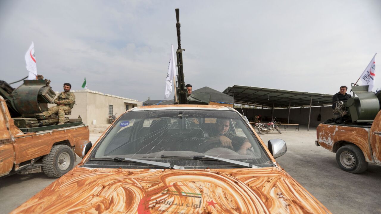 Turkish-backed Syrian rebel fighters, mask-clad due to the COVID-19 coronavirus pandemic, take part in a military parade marking the graduation of a new batch of cadets and attended by officials from the Turkey-backed opposition in the town of Jindayris, in the Afrin region of the northern Syrian rebel-held province of Aleppo, on November 14, 2020. (Photo by Bakr ALKASEM / AFP) (Photo by BAKR ALKASEM/AFP via Getty Images)