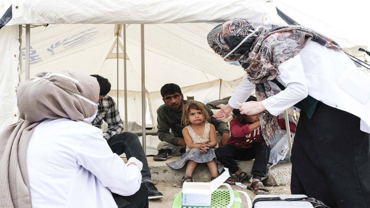 DOHUK, IRAQ - OCTOBER 17: Syrian refugees children who fled the Turkish incursion in Northern Syria receive medicine for polio and measles as more than 200 arrive at the facility on October 17, 2019 in Dohuk, Iraq. More than 1000 refugees have arrived in Northern Iraq since the beginning of the conflict, with many saying they paid to be smuggled through the Syrian border. (Photo by Byron Smith/Getty Images)