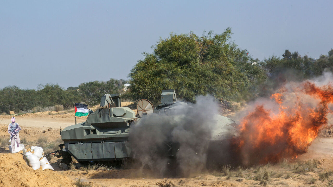 Fighters take part in military exercises by Palestinian armed factions, featuring mock Israeli military targets and vehicles, at a military site in Rafah in the southern Gaza Strip, on December 29, 2020. - Palestinian armed groups staged military exercises in Gaza, including firing rockets into the sea, to mark the anniversary of the start of the 2008 conflict with Israel. (Photo by SAID KHATIB / AFP) (Photo by SAID KHATIB/AFP via Getty Images)