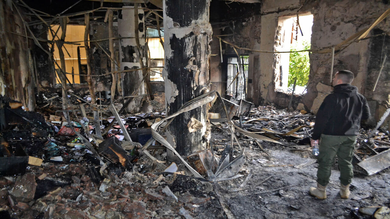 People inspect a burnt room at municipality building, in the impoverished northern Lebanese port city of Tripoli, after anti-government protesters hurled improvised incendiary devices amid clashes with security forces the previous night, on January 29, 2021. (Photo by Fathi AL-MASRI / AFP) (Photo by FATHI AL-MASRI/AFP via Getty Images)