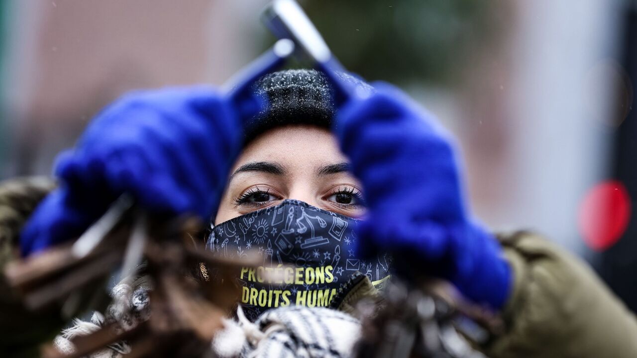 An activist of the human rights NGO Amnesty International takes part in an action in front of the embassy of Saudi Arabia in Brussels on January 8, 2021, calling for the release of jailed Saudi blogger Raif Badawi. - Badawi was sentenced to 10 years in prison and 1,000 lashes for insulting Islam. (Photo by Kenzo TRIBOUILLARD / AFP) (Photo by KENZO TRIBOUILLARD/AFP via Getty Images)