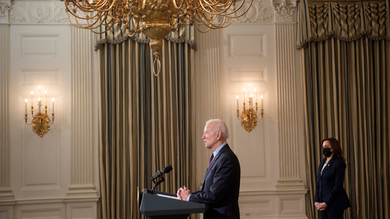 US Vice President Kamala Harris (R) listens while US President Joe Biden speaks about COVID-19 relief from the State Dining Room of the White House February 5, 2021, in Washington, DC. (Photo by Brendan Smialowski / AFP) (Photo by BRENDAN SMIALOWSKI/AFP via Getty Images)