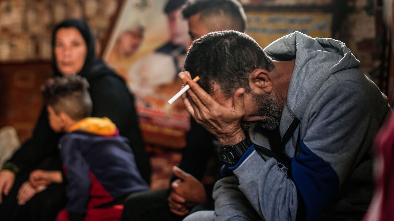 Hadi, the father of Mohammad one of the four victims of the extended Bakr family gather at their house in al-Shati refugee camp in Gaza City on February 7, 2021, surrounded by posters in memory of four children who were killed while playing on the beach during the 2014 Israeli-Palestinian conflict in Gaza. - The International Criminal Court's ruling that it has jurisdiction over the situation in the Palestinian territories opens the way to it investigating alleged war crimes committed in the 2014 Israeli-Pa