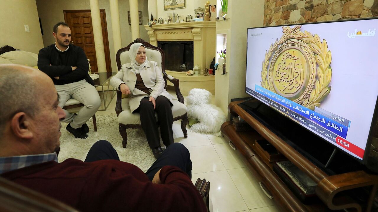 Sahar Qawasmeh (C), member of the Palestinian Legislative Council (PLC) representing the Fatah movement, watches the coverage of the Egypt-hosted Palestinian National Dialogue at her home in the the West Bank city of Hebron on February 8, 2021. (Photo by HAZEM BADER / AFP) (Photo by HAZEM BADER/AFP via Getty Images)