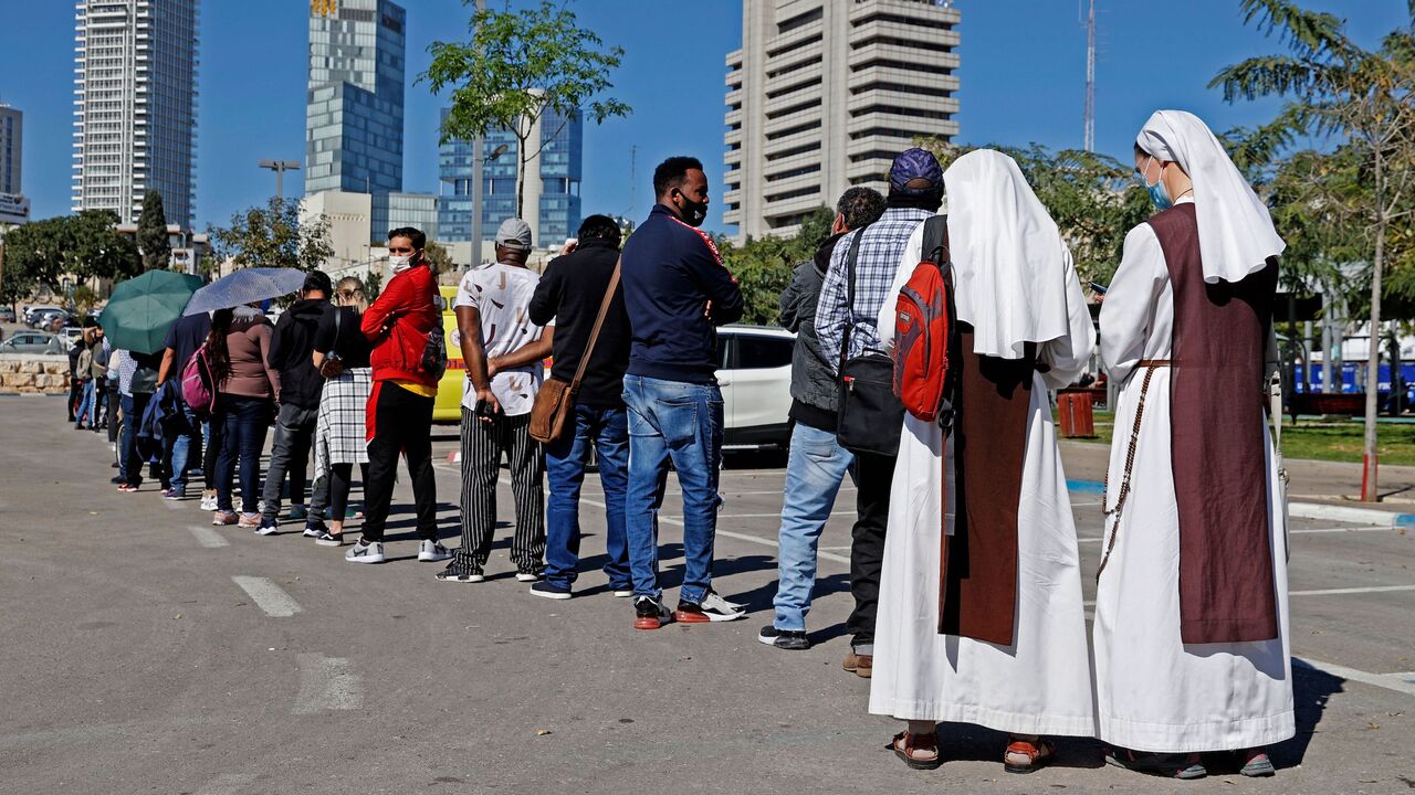 French nuns living in Israel queue with other foreign residents to receive a dose of COVID-19 coronavirus vaccine at the Tel Aviv Sourasky Medical Centre for foreign nationals in the Mediterranean coastal city of Tel Aviv on February 9, 2021 during a campaign to vaccinate foreign workers and refugees against coronavirus. (Photo by JACK GUEZ / AFP) (Photo by JACK GUEZ/AFP via Getty Images)
