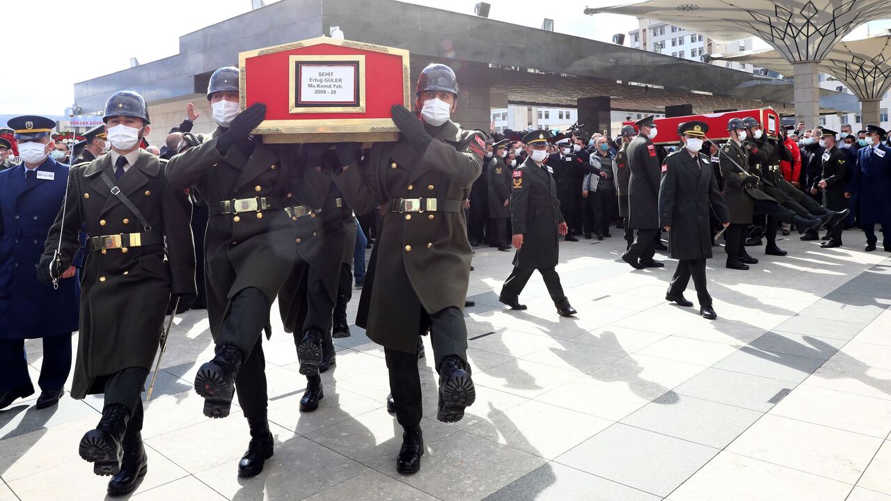 The coffins of three Turkish military personnel killed in action are carried during funeral prays at the Ahmet Hamdi Akseki Mosque in Ankara on February 12, 2021. - The three soldiers Lt. Burak Coskun, Lt. Ertug Guler and Sgt. First Class Harun Turhan were killed during clashes with Kurdish militants in northern Iraq's Gara region as part of the Eagle Claw 2 operation by the Turkish military against the outlawed Kurdistan Workers' Party (PKK). (Photo by Adem ALTAN / AFP) (Photo by ADEM ALTAN/AFP via Getty I