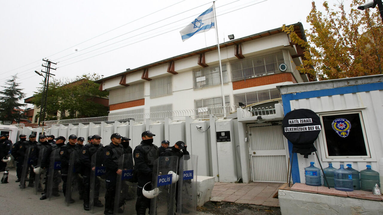Riot police stand in formation as unseen Turkish protesters demonstrate against Israel's attack on Gaza outside the Israeli embassy in Ankara on November 21, 2012. Turkish Prime Minister Recep Tayyip Erdogan on Tuesday accused Israel of "ethnic cleansing" in Gaza, saying the Jewish state's air raids could not be considered self-defence.  AFP Photo/ADEM ALTAN        (Photo credit should read ADEM ALTAN/AFP via Getty Images)