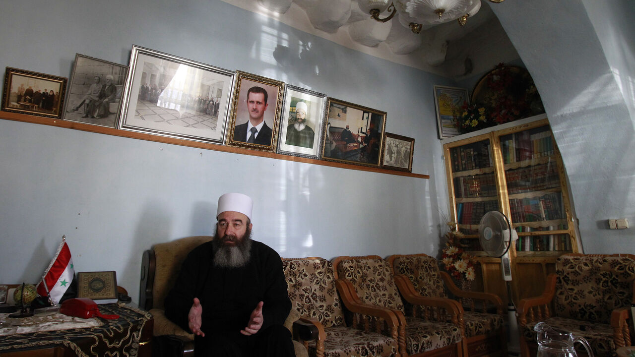 TO GO WITH AFP STORY BY SAMMY KETZ
Sheikh Hikmat Hajari, a top Druze cleric, sits in his home in the southern city of Sweida on January 23, 2013. Abductions of Druze officials in Daraa were rampant in May and June of last year, prompting the inhabitants of Sweida to respond in kind, leaving behind a palpable distrust between the provinces, though Sweida hosts some 9,000 displaced people of Daraa. AFP PHOTO/ANWAR AMRO        (Photo credit should read ANWAR AMRO/AFP via Getty Images)