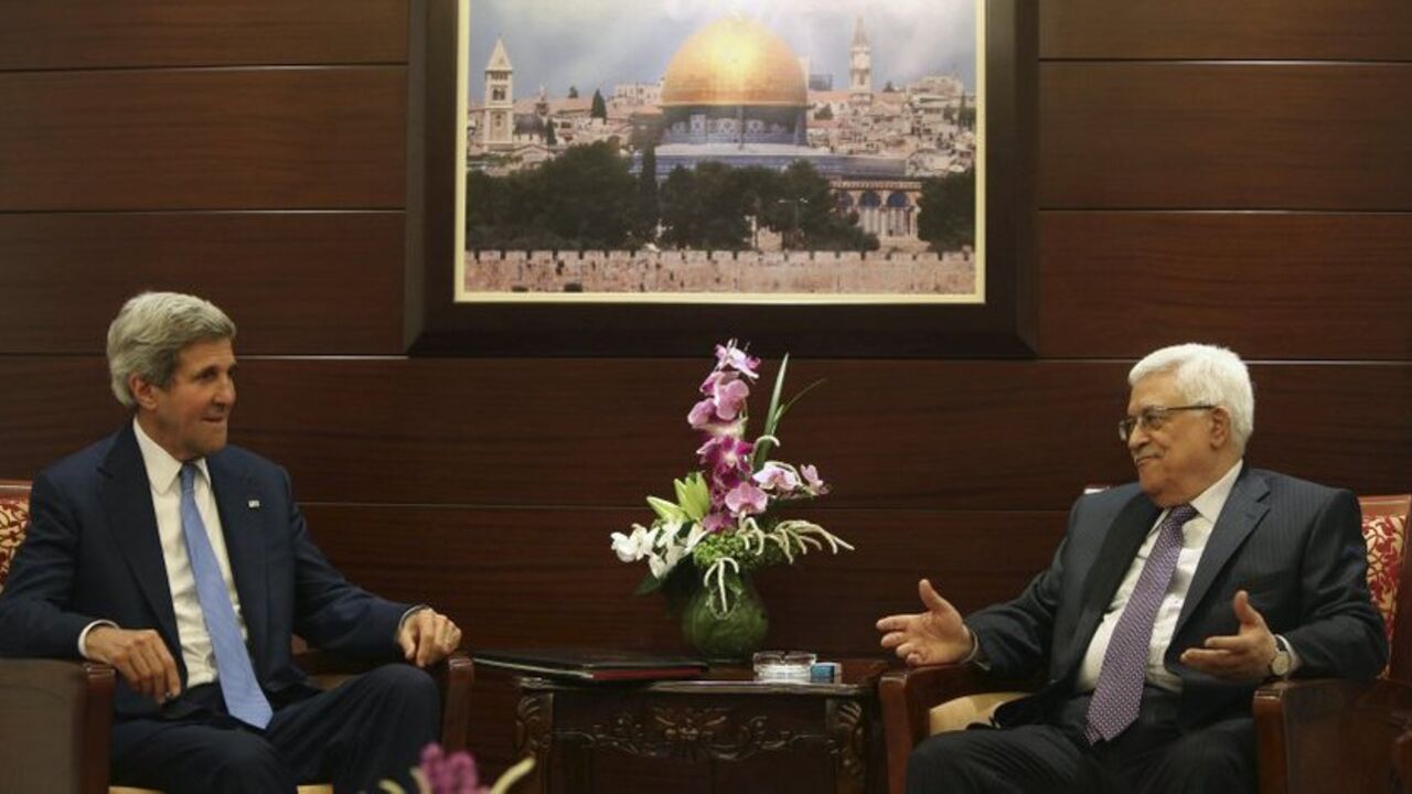 Palestinian President Mahmoud Abbas (R) gestures during a meeting with U.S. Secretary of State John Kerry in the West Bank city of Ramallah July 19, 2013.  REUTERS/Fadi Arouri/Pool (WEST BANK - Tags: POLITICS) - RTX11S3S