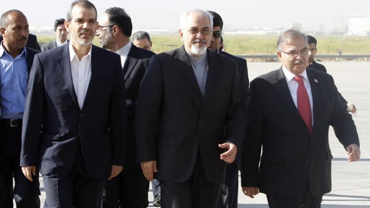 Iran's Foreign Minister Mohammad Javad Zarif (C) arrives at Baghdad International Airport September 8, 2013. Zarif visited Iraq on Sunday to discuss what he called the "dangerous situation" in Syria and the wider region.  REUTERS/ Saad Shalash  (IRAQ - Tags: POLITICS) - RTX13CKO