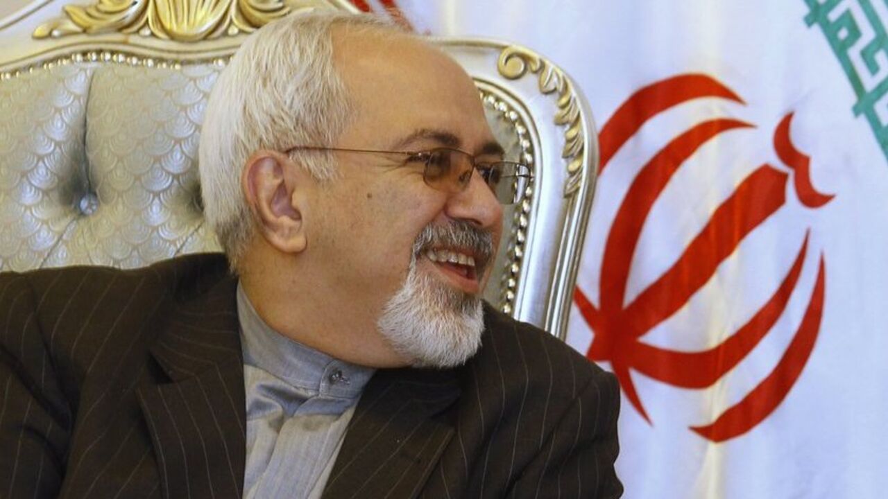 Iran's Foreign Minister Mohammad Javad Zarif smiles during a meeting with his Iraqi counterpart Hoshyar Zebari (not in picture) at the Baghdad International Airport September 8, 2013. Zarif visited Iraq on Sunday to discuss what he called the "dangerous situation" in Syria and the wider region.   REUTERS/ Saad Shalash  (IRAQ - Tags: POLITICS) - RTX13CKS