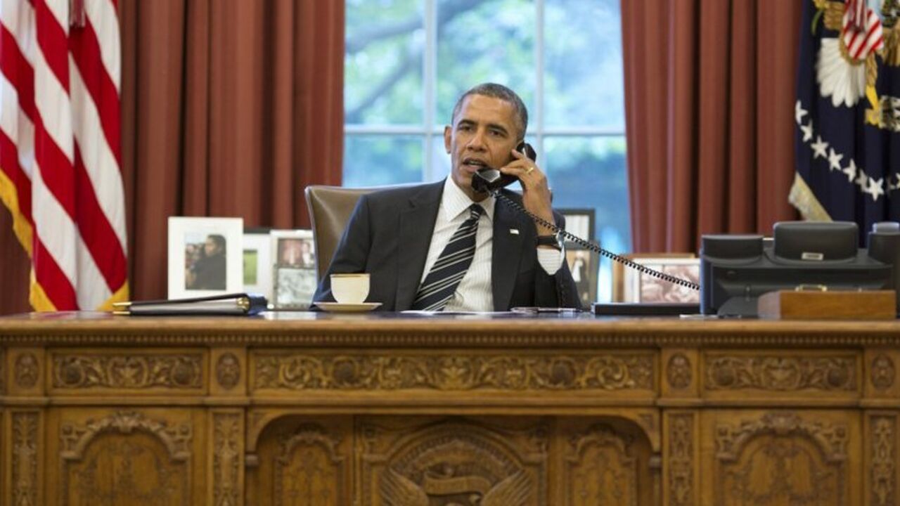 U.S. President Barack Obama talks with Iranian President Hassan Rouhani during a phone call in the Oval Office at the White House in Washington September 27, 2013. U.S. President Barack Obama and new Iranian President Hassan Rouhani held the historic phone call on Friday, in the highest level conversation between the estranged nations in more than three decades. Speaking to reporters at the White House, Obama said both men had directed their teams to work expeditiously toward an agreement on Iran's nuclear 